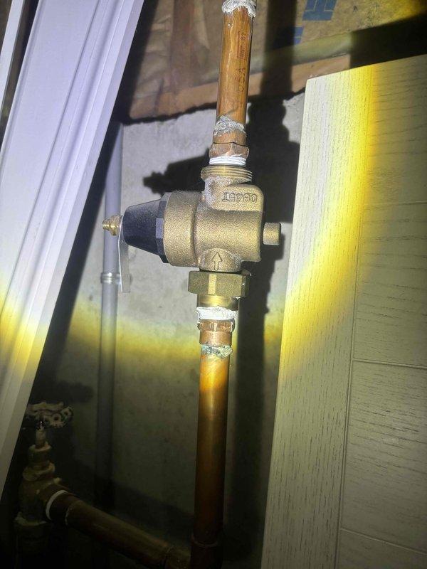 Performed comprehensive whole home plumbing inspection with special focus on the main water supply system. Inspected brass pressure regulator valve (IPSO brand) and associated copper piping, noting some natural tarnishing and aging of components but confirming all connections remain properly soldered and functional. No immediate issues requiring repair were identified during the inspection.