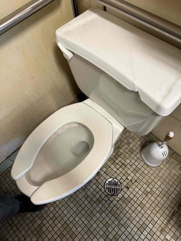 Completed estimate for commercial restroom with two toilet fixtures requiring repair. First toilet identified as loose at floor mounting with evidence of water leakage at base, requiring reset with new wax ring and flange bolts. Second toilet diagnosed with inadequate flush performance due to partial blockage or flush valve malfunction, requiring further evaluation of flush mechanism and trapway clearance. Documented existing conditions of both squat-style toilet fixture and standard toilet installation for repair specifications.