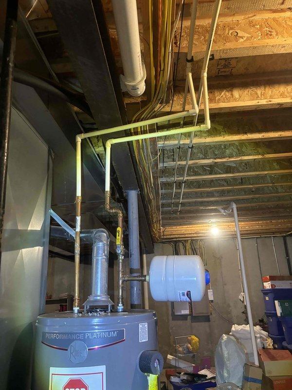 Completed comprehensive whole-home plumbing inspection during morning appointment window. Thoroughly examined all accessible plumbing systems including water heater installation, supply and drain lines, gas piping with proper certification tags, expansion tank mounting, and basement utility area infrastructure. All systems photographed and documented, with copper piping, PVC drainage, and mechanical connections assessed for proper installation and current condition.