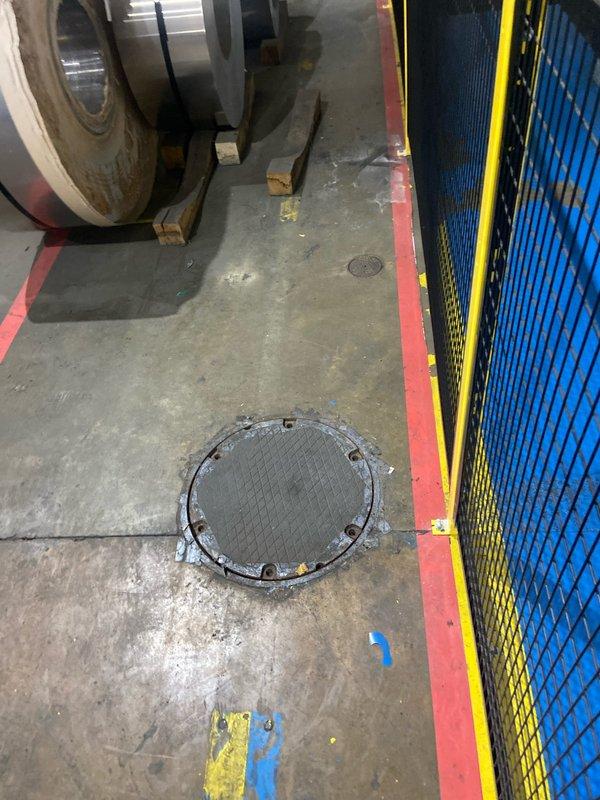 Conducted site assessment of grinder pump system accessed through floor-mounted access port in commercial facility. Evaluated existing pump conditions, documented corroded access ring and manhole cover, and provided detailed estimate for grinder pump replacement including associated components and installation requirements.
