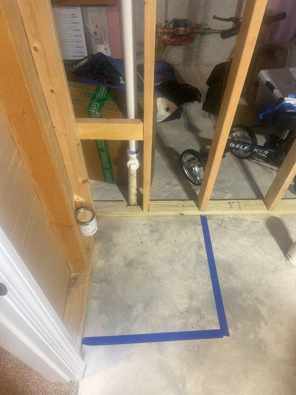 Completed plumbing estimate for new basement bathroom installation. Assessed existing rough-in location with PVC drain stack protruding from concrete floor in framed area marked for fixture placement. Documented site conditions, existing mechanical systems, and determined piping requirements for water supply and drainage connections to accommodate planned bathroom fixtures.
