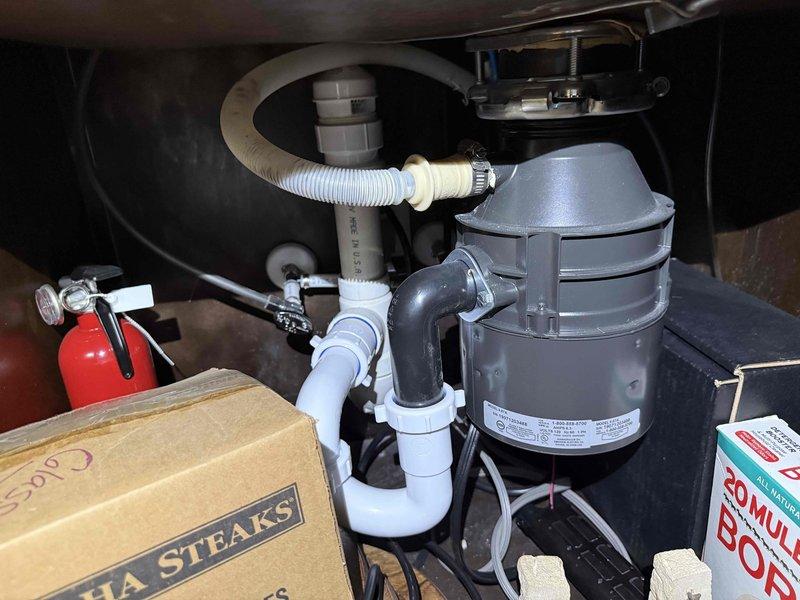 # Plumbing Maintenance Completed

Performed comprehensive plumbing maintenance on residential property addressing multiple leaking faucets throughout the house. Inspected kitchen sink plumbing system including garbage disposal unit, P-trap configuration, and dishwasher connection line to verify proper operation and check for leaks. Examined basement utility area plumbing including white PVC drainage and ventilation piping system with multiple elbows and joints running along framed walls. All accessible plumbing fixtures and connections were evaluated for wear, corrosion, and proper function. Tightened connections and replaced worn components as needed to eliminate leaks and restore proper water flow. Verified all repairs were secure and tested systems for proper drainage and operation before completing maintenance service.