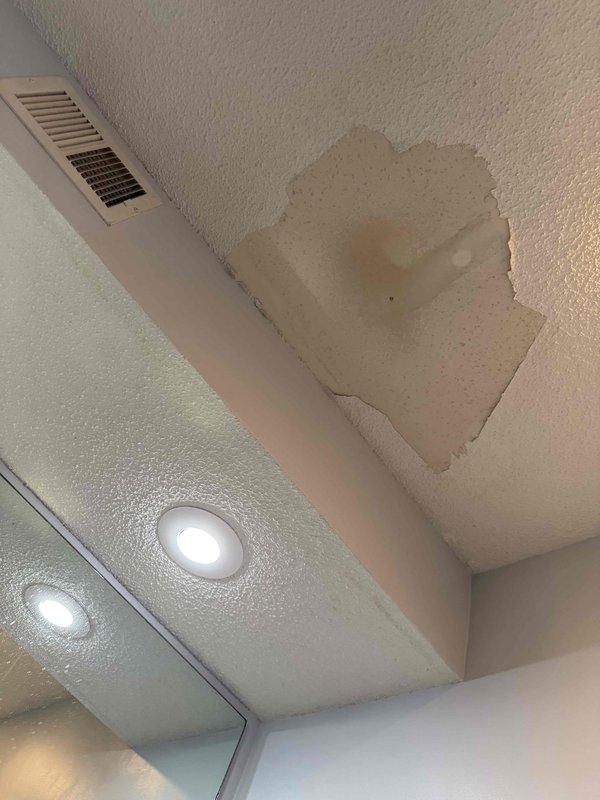 Responded to service call for broken faucet in master bathroom tub. Upon arrival, replaced defective faucet handles and installed new chrome spout assembly. During inspection, identified water damage on ceiling indicating previous leak from plumbing fixture, which was documented with photographs for customer awareness. All faucet components were properly secured and tested for functionality and leaks before completing the service.