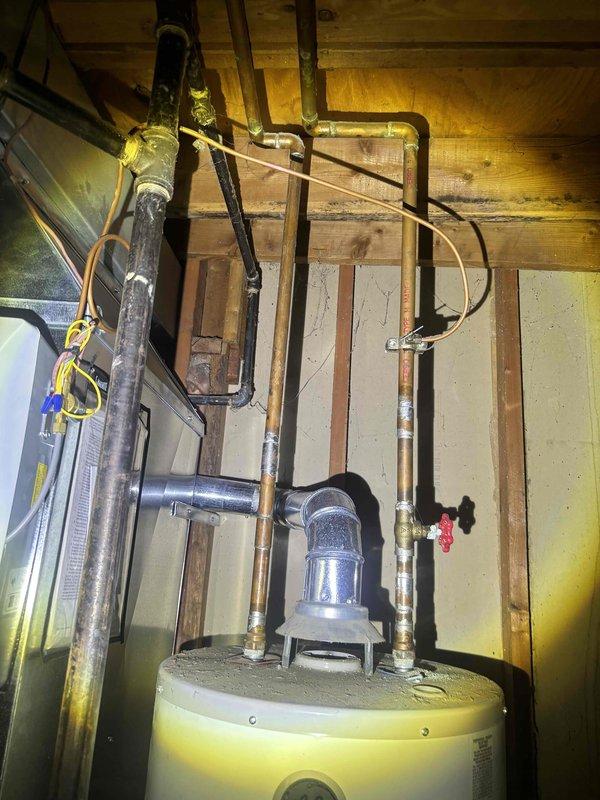 Conducted on-site assessment of leaking 40-gallon residential water heater located in basement utility area. Inspected existing unit, noting active water leakage evidenced by concrete floor staining and moisture accumulation around base of tank. Evaluated current installation configuration including copper and galvanized supply lines, gas control valve assembly, pressure relief valve, and associated plumbing connections showing age-related corrosion and mineral deposits. Documented existing equipment specifications, venting requirements, and spatial constraints for replacement planning. Photographed current installation setup including pipe routing, connection points, and surrounding mechanical systems to develop accurate replacement estimate. Provided comprehensive quote for complete water heater replacement including removal and disposal of failed unit.