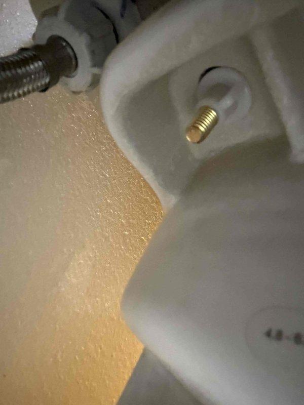 Responded to reported toilet leak penetrating ceiling into living room below and low hot water pressure at washing machine supply. Upon inspection, identified failed toilet mounting flange and supply line connection as source of water intrusion. Removed toilet, replaced wax ring seal and reinstalled closet bolts with proper mounting hardware to ensure watertight seal between fixture and drain pipe. Inspected washing machine hot water supply valve and determined restricted flow due to partially closed angle stop valve. Adjusted valve to full open position and verified restored water pressure to appliance. Confirmed no active leaks at toilet base and tested flush cycles to verify proper drainage and seal integrity.