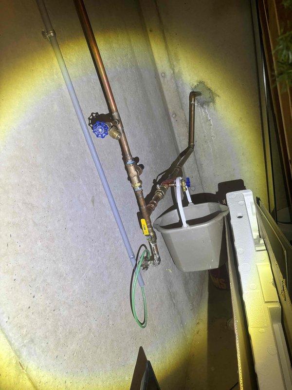 Replaced defective hose bib and backflow preventer with new brass fixtures and copper piping connections. Installation included proper mounting of components on exterior wall panel, ensuring code-compliant backflow prevention and functional outdoor water supply. All connections tested and verified leak-free upon completion.