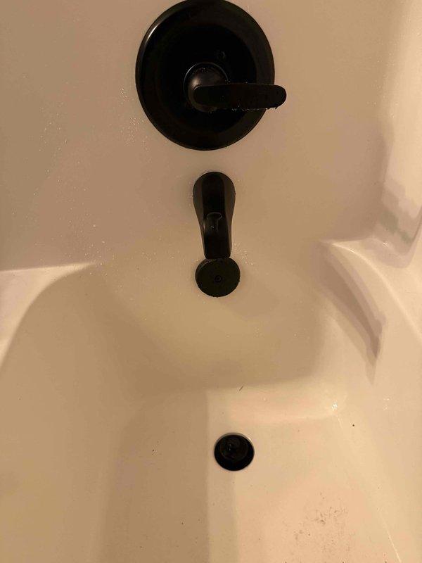 Successfully installed shower trim kit including single-handle control valve, tub spout with diverter, and escutcheon plate in dark bronze finish. Additionally, pulled and reset toilet with new wax ring and stool bolts to address seal integrity and ensure proper function of the fixture.