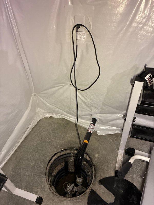 Conducted an on-site evaluation of an existing sump pump system in a basement to provide an estimate for adding a battery backup unit. Inspected the current submersible sump pump installation within the concrete sump pit, assessed the electrical connections, and evaluated the workspace conditions including proper containment measures with plastic sheeting. Documented the existing pump configuration, discharge piping, and pit dimensions to determine compatibility and requirements for integrating a battery backup system to ensure continued operation during power outages.