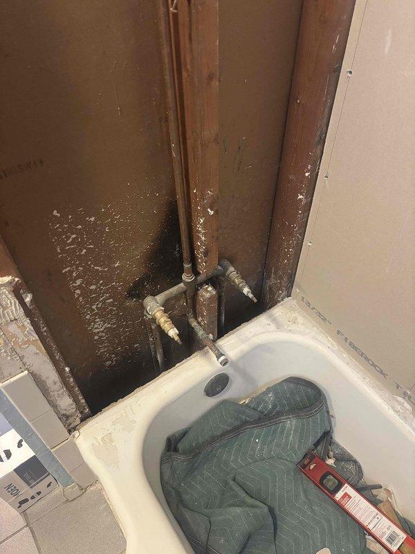 Installed customer-supplied shower valve in bathroom undergoing renovation. Completed rough-in plumbing connections, secured valve to exposed framing, and verified proper operation of mixing mechanism and temperature control. Protected existing bathtub fixture with moving blanket during installation work.