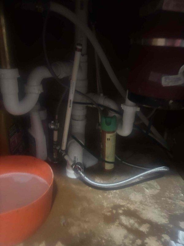 Responded to kitchen sink clog complaint and accessed cabinet area beneath sink to inspect drainage system. Upon examination, found P-trap assembly and associated PVC drain lines showing signs of blockage. Cleared obstruction from drain line, ensuring proper water flow through P-trap configuration and downstream piping. Tested system operation to verify drainage functioning correctly. Advised on proper sink usage to prevent future clogs.