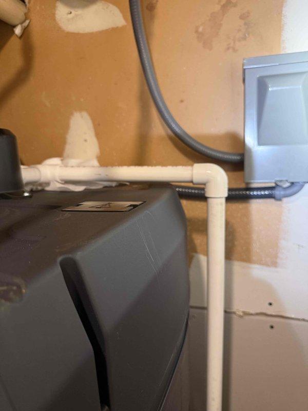 Installed Essency EXR on-demand electric water heater, 50-gallon capacity with 80-gallon equivalent output and 0.93 UEF rating. Connected copper supply lines to unit, established proper drainage with PVC piping, and integrated electrical connections through wall-mounted junction box. Positioned unit in basement utility area adjacent to existing HVAC system with appropriate clearances, verified digital display panel functionality, and confirmed all plumbing connections are secure and leak-free.