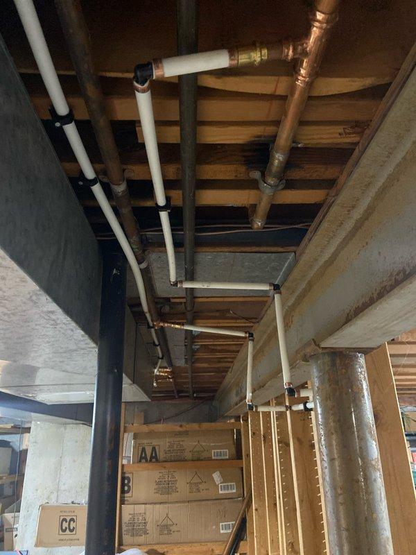 Completed comprehensive plumbing renovation including removal of existing three-handle tub/shower valve and installation of customer-supplied single-handle valve with raised shower head height. Main water supply was shut off to facilitate valve replacement, with all rough-in work prepared for drywall and tile installation. Trim kit installation scheduled for follow-up visit after tile work completion.

Installed customer-supplied utility sink with complete drain line reconfiguration to achieve proper alignment. Tapped into existing hot and cold water lines above sink location, running new supply lines down wall with individual shut-off valves. Connected sink drain assembly and faucet supply lines, completing full leak testing.

Replaced frost-free outside hose bib and installed new 1/2-inch ball valve in basement to allow isolated shut-off of exterior fixture without interrupting whole-house water supply. Installed two quarter-turn angle stops for kitchen and bathroom sink faucets.

Co