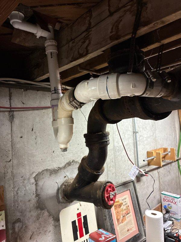 Completed main line horizontal drain line replacement in basement area. Removed deteriorated drainage piping and installed new PVC drainage system with proper pitch and connections to existing plumbing infrastructure. Work included securing new piping to floor joists with appropriate hangers and ensuring all joints were properly sealed for code compliance.