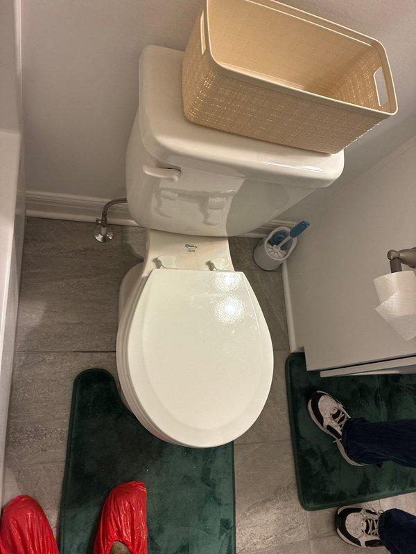 Responded to service call for toilet replacement estimate at residential property. Upon arrival, assessed existing standard white porcelain toilet in bathroom equipped with accessibility features including padded grab bars. Documented current fixture condition and surrounding bathroom configuration, noting gray vinyl plank flooring and adequate clearances. Evaluated installation requirements for potential replacement, including existing water supply line connection and floor flange accessibility. Photographed existing toilet and bathroom layout to provide accurate estimate for new fixture installation. Recommended replacement options based on bathroom dimensions and accessibility needs.