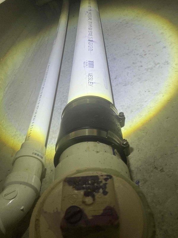 Responded to plumbing issue where hot water was leaking from the hot water knob when only the cold water valve was activated. Inspected under-sink plumbing components including flexible supply lines, shut-off valves, and connections to identify cross-connection or valve failure causing the anomaly. Documented existing plumbing configuration with supply lines, drain assembly, and valve hardware for diagnostic purposes and potential repair recommendation.