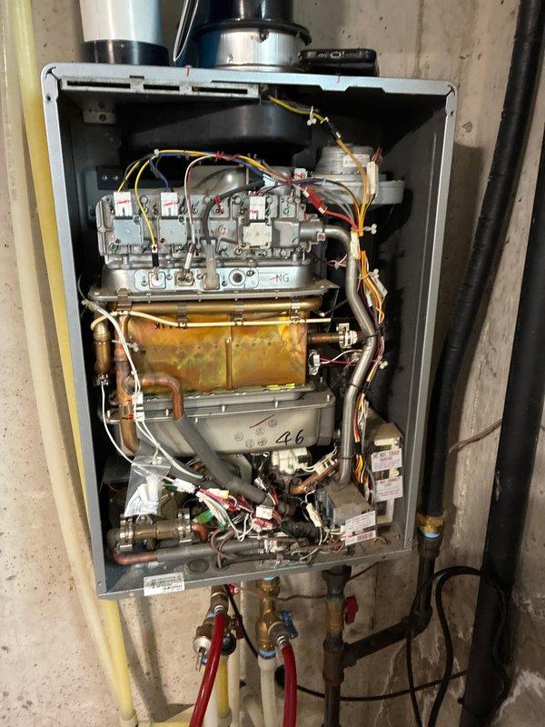 Responded to service call for tankless water heater experiencing operational issues in basement installation. Upon inspection of the 5-6 year old unit, identified severely clogged inlet filter screen causing reduced water flow and performance problems. Removed and cleaned the contaminated filter assembly, which showed significant accumulation of sediment and debris. Performed comprehensive internal inspection of the unit, examining the heat exchanger, gas combustion components, electrical connections, and water supply lines. Verified proper operation of all safety controls, ignition system, and flow sensors. Tested unit functionality following filter cleaning and confirmed restoration of proper hot water delivery and temperature consistency.