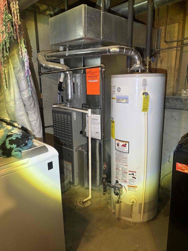 Responded to no-hot-water call for GE tanked water heater located in basement mechanical room. Upon arrival, performed visual inspection and diagnostic testing of unit. Found gas supply intact and pilot light assembly functioning properly. Verified burner ignition sequence and observed proper flame pattern with characteristic blue flames at base indicating efficient combustion. Checked thermocouple operation and gas valve functionality. Restored unit to full operational status with burner firing correctly in circular pattern. Verified adequate draft and proper venting. Unit tested and confirmed producing hot water at appropriate temperature settings.