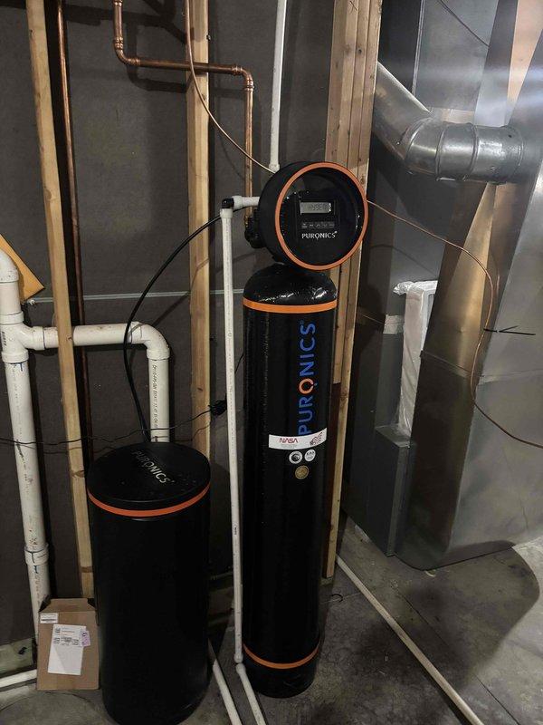 Performed carbon media replacement on Puronics water softening system. Removed existing carbon filter media from treatment tank and recharged unit with fresh activated carbon to restore optimal water filtration and taste/odor removal capabilities. Verified control valve settings and programming on digital controller. Inspected system plumbing connections, including PVC inlet/outlet piping, for proper operation and absence of leaks. Tested system cycling and regeneration functions to ensure proper performance. System returned to full operational status with improved water treatment efficiency.