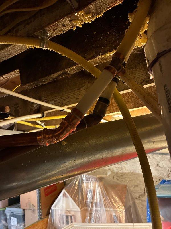 Replaced frost-free outside hose bib with new unit featuring cross-handle valve assembly mounted to exterior wall. Removed existing drywall around laundry area to access and replace failed laundry box with new code-compliant unit including pre-installed water hammer arrestors. Replaced leaking 1/2" PEX fittings at main supply lines and re-established connections to laundry box supply lines. Conducted pressure testing to verify all connections were leak-free and system was functioning properly.