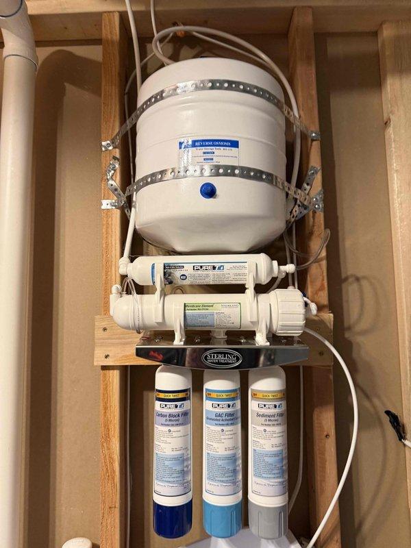 Responded to service call for reverse osmosis system repair where homeowner damaged a 3/8" elbow fitting during filter replacement. Replaced broken fitting with new brass compression elbow and reassembled RO filter system connections ensuring proper water flow direction and secure leak-free joints. Verified system operation, checked for leaks at all connection points, and confirmed proper filtration sequence through multi-stage filter housings and pressure tank.