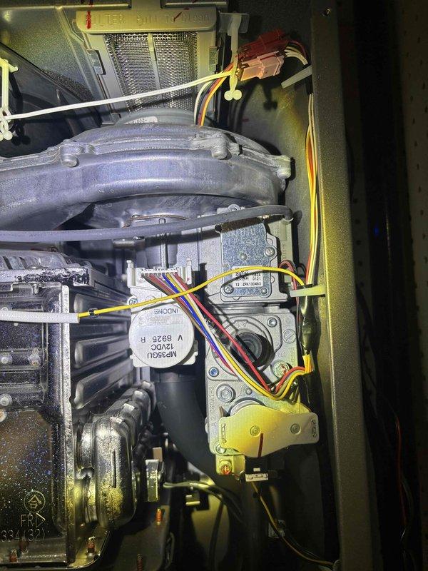 Completed routine plumbing maintenance inspection of HVAC system components, including examination of gas valve assembly, control module connections, and associated piping. Inspected blower housing, heat exchanger manifold, electrical wiring harnesses, and valve connections; noted presence of condensation on interior surfaces and verified all mechanical fasteners and connection points were secure.