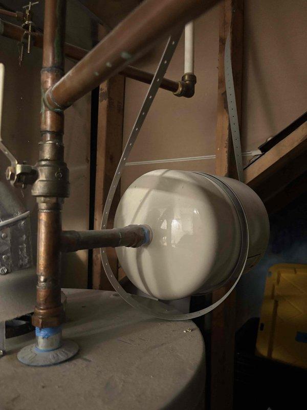 Responded to reported water heater leak in basement mechanical room. Upon inspection, identified excessive condensation on water heater tank and associated plumbing components due to humidity conditions in unfinished basement space. Examined expansion tank, copper supply lines, pressure relief valve, and all connection points for active leaks. Verified all fittings, valves, and pipe connections were secure with no signs of water seepage or dripping from plumbing joints. Determined moisture accumulation on tank surface was environmental condensation rather than tank failure or plumbing leak. Inspected water heater for structural integrity and proper operation. All components functioning within normal parameters with no evidence of tank corrosion or compromised integrity requiring replacement.