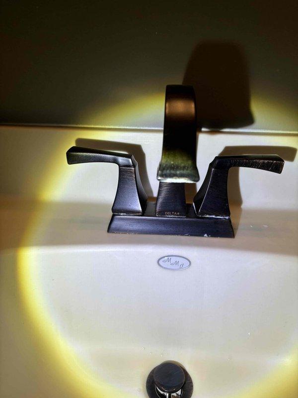 Completed routine plumbing maintenance including water softener service and salt replenishment. Inspected bathroom plumbing fixtures, including Delta brand faucets in brushed nickel and oil-rubbed bronze finishes, verified proper operation of sink drains and handles, and confirmed all fixtures were functioning correctly with no leaks detected.