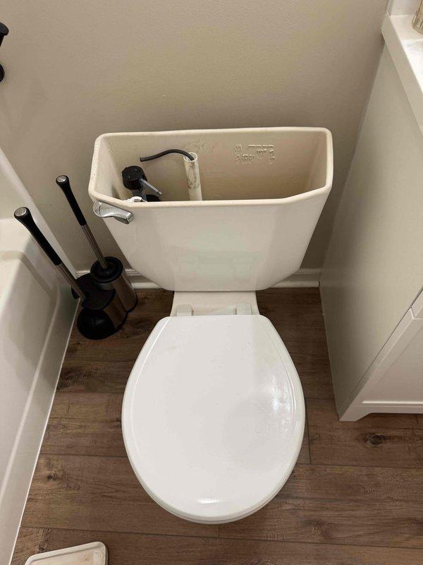 Responded to guest bathroom toilet issue with reported backing up and continuous running. Upon inspection, identified faulty flapper valve and fill valve assembly causing constant water flow into tank. Removed tank lid and examined internal flush mechanism components. Replaced worn flapper and adjusted fill valve to proper water level. Tested flush cycle multiple times to ensure proper operation and verified no continuous running. Confirmed toilet bowl drainage functioning correctly with no backup issues. Additionally, adjusted water heater temperature setting on lower level unit per request to increase hot water output temperature.