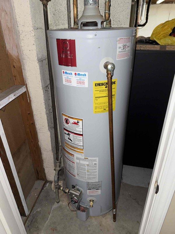 Responded to service call for kitchen sink drainage issue. Upon arrival, performed inspection of kitchen plumbing system and documented existing water heater installation in utility area. Water heater unit identified as 50-gallon natural gas automatic storage model (GS950YBRT) manufactured in 2006, with all safety labels and specifications intact. Addressed reported drainage problem through standard drain clearing procedures to restore proper flow to kitchen sink.