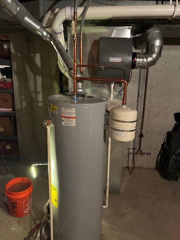 # Plumbing Preventive Maintenance Completed

Performed comprehensive plumbing preventive maintenance on residential water heater and associated systems. Inspected water heater tank condition, verified proper operation of temperature and pressure relief valve, checked all copper supply and discharge piping connections for leaks or corrosion, and examined expansion tank mounting and pressure settings. Evaluated PVC drain line configuration, tested electronic control unit functionality, and confirmed proper venting arrangements. Assessed overall system performance including sediment accumulation indicators and burner operation. All plumbing components found operating within normal parameters with no immediate repairs required at this time.