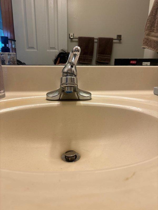 Completed bathroom faucet installation using customer-supplied chrome single-handle fixture with curved spout. Removed existing faucet, installed new unit with proper mounting and supply line connections, and verified proper drainage and water flow operation with no leaks detected.