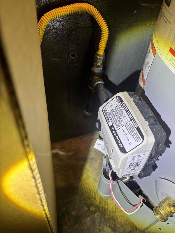 Performed plumbing maintenance inspection on water heater system and associated components. Inspected gas control valve, flexible gas connector line, and electronic control module for proper operation and safety compliance. Examined exterior cleanout access cover in yard area, verifying accessibility and condition. All equipment found to be functioning within normal parameters.