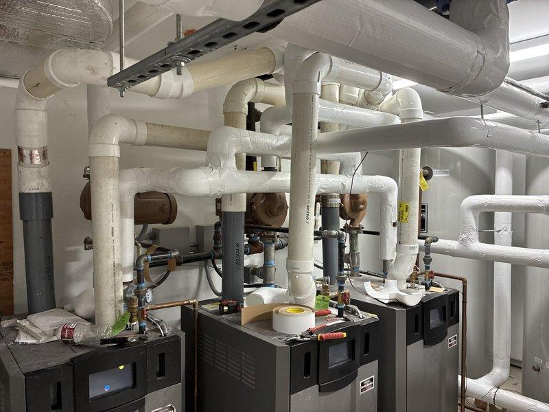 Completed commercial gas piping installation in mechanical room serving multiple HVAC units. Installed and insulated gas distribution system with proper routing, support brackets, and connections to four heating/cooling units, ensuring all piping met code requirements for commercial applications. System was pressure tested and verified operational with all connections properly secured and insulated per specifications.