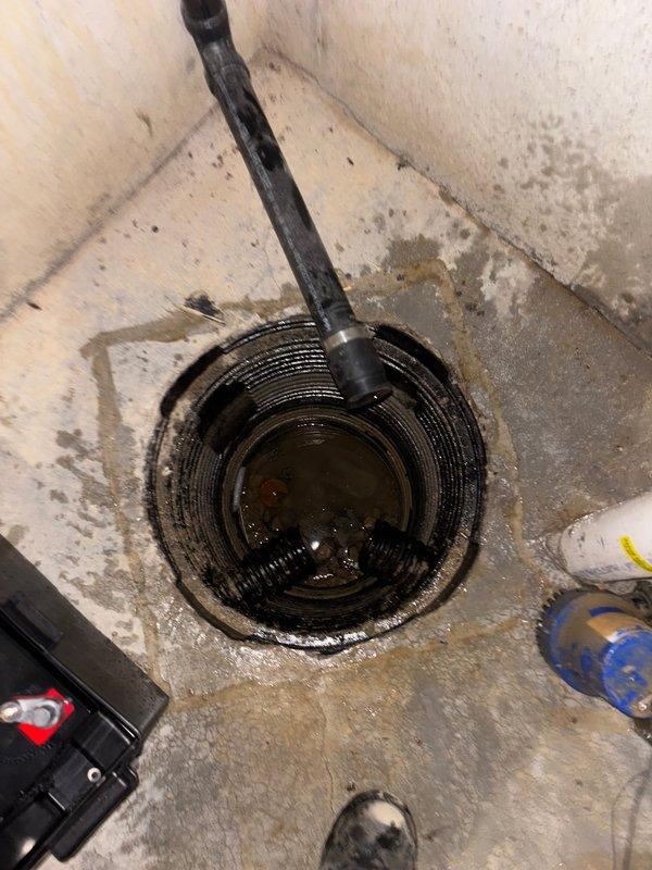 Completed installation of customer-supplied sump pump system in basement utility area. Installed pump unit into existing corrugated plastic basin with proper discharge piping configuration, connected electrical power supply, and verified operational functionality. The system was tested to ensure proper water removal capability from the pit, with all components secured and ready for service.
