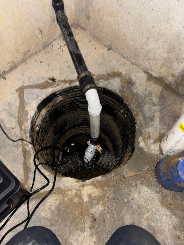 Completed installation of customer-supplied sump pump system in basement utility area. Installed pump unit into existing corrugated plastic basin with proper discharge piping configuration, connected electrical power supply, and verified operational functionality. The system was tested to ensure proper water removal capability from the pit, with all components secured and ready for service.