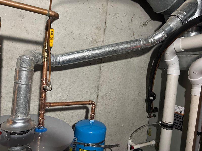 Responded to service call for leaking water heater and successfully completed same-day installation of 50-gallon gas water heater. Removed failed unit, installed replacement with proper copper supply line connections, pressure relief valve, expansion tank, shutoff valves, and code-compliant venting using PVC piping, restoring hot water service to the property.