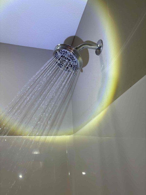 Completed preventive plumbing maintenance inspection on residential bathroom fixtures. Tested shower head water flow and spray pattern, confirming proper operation with adequate pressure distribution across all nozzles. Inspected water supply connection assembly, including shut-off valve, braided stainless steel supply line, and wall-mounted escutcheon plate for secure mounting and absence of leaks. All fixtures functioning properly with no deficiencies noted.