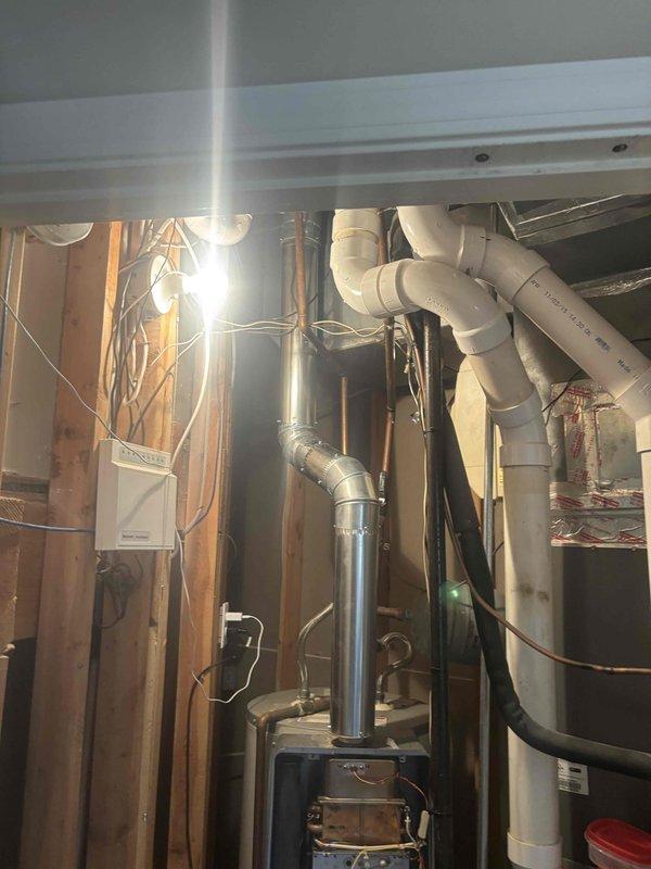 Performed comprehensive maintenance on a Rinnai RH-180 tankless water heater involving complete disassembly and manual cleaning of the heat exchanger assembly. The heat exchanger exhibited significant corrosion and oxidation buildup on the copper coil tubes and surrounding metallic components, with visible green patina indicating prolonged exposure to moisture and mineral deposits. Removed all four parallel cylindrical tubes from the housing, thoroughly cleaned the spiral fins and connecting points to remove accumulated scale and corrosion, then reassembled the unit to restore optimal heat transfer efficiency and extend equipment lifespan.