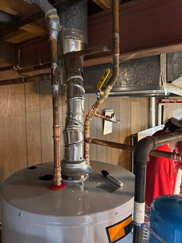 Installed a 50-gallon gas water heater in the basement utility area, complete with all necessary plumbing connections including copper supply lines, gas line hookup, and proper venting through metallic ductwork. A thermal expansion tank was mounted to the cold water supply line to protect against pressure fluctuations in the system. All connections were tested and verified operational, with appropriate safety valves and shutoff mechanisms installed per code requirements.
