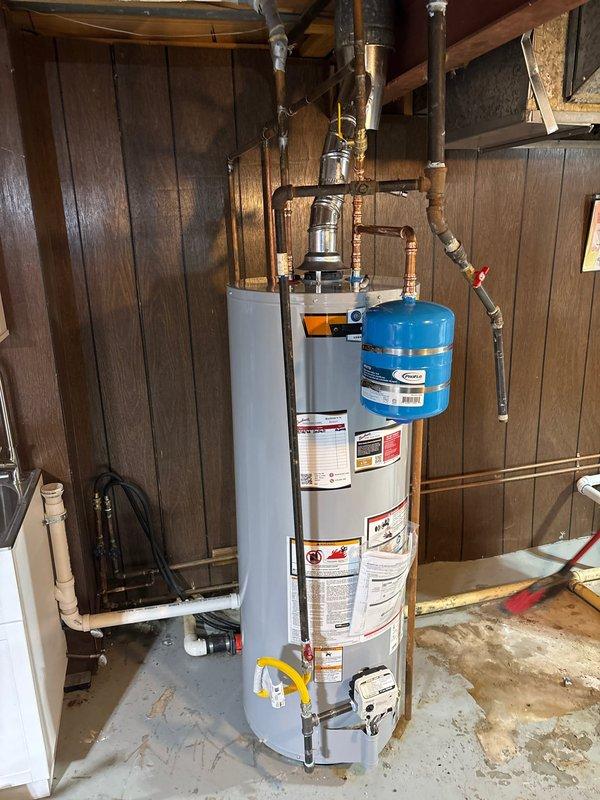 Installed a 50-gallon gas water heater in the basement utility area, complete with all necessary plumbing connections including copper supply lines, gas line hookup, and proper venting through metallic ductwork. A thermal expansion tank was mounted to the cold water supply line to protect against pressure fluctuations in the system. All connections were tested and verified operational, with appropriate safety valves and shutoff mechanisms installed per code requirements.