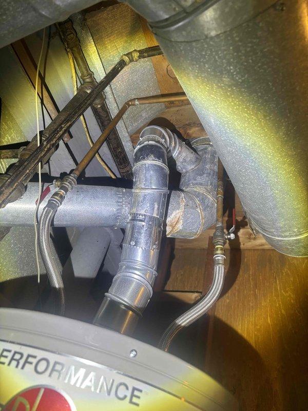 Completed preventative plumbing maintenance inspection on residential property. Verified proper operation of bathroom shower fixture with handheld showerhead, confirmed adequate water flow and spray pattern, and inspected plumbing connections behind access panel. Examined mechanical system components including filter assembly, refrigerant lines with brass fittings, and associated ductwork insulation for signs of leaks or deterioration. All fixtures and connections found to be functioning within normal parameters with no immediate repairs required.