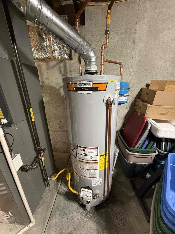 Removed and disposed of six-year-old 50-gallon gas water heater exhibiting defective temperature and pressure relief valve and failed thermal expansion tank, both components no longer covered under warranty. Installed new 50-gallon gas State brand water heater with copper piping connections, brass fittings, and valves. Additionally installed new thermal expansion tank and pressure reducing valve to protect the system and ensure proper water pressure regulation. All connections tested and verified for proper operation with one-year labor warranty and six-year manufacturer's warranty provided.