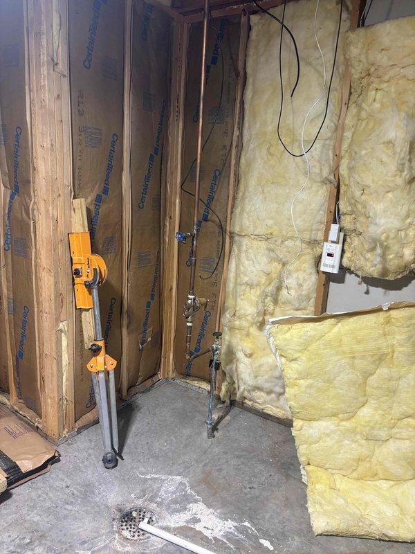 Completed recurring plumbing maintenance inspection of residential property. Verified kitchen sink faucet operation and drainage system functionality, confirming proper water flow and no leaks present. Inspected basement area with exposed plumbing lines and floor drain to ensure all systems operating within normal parameters.