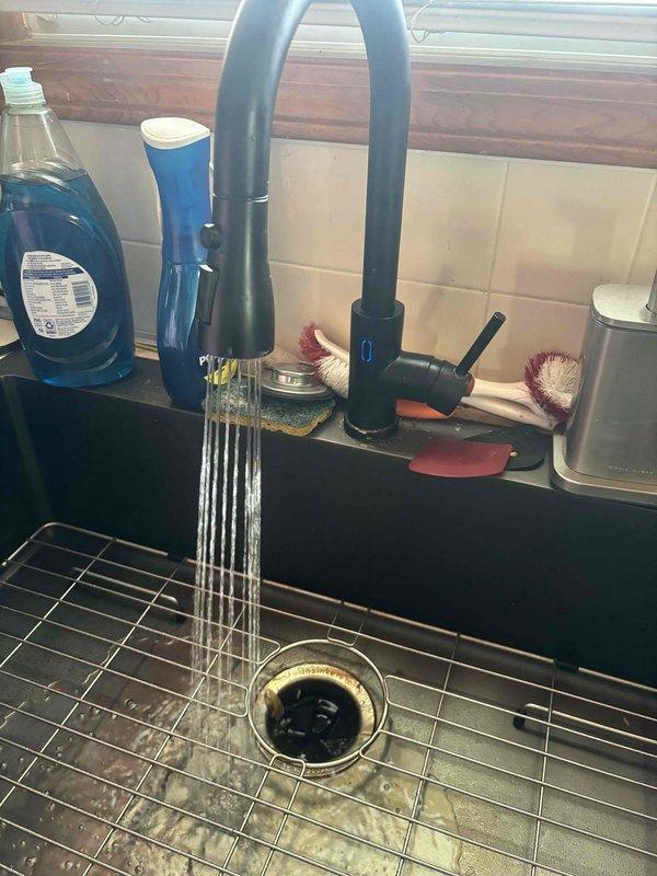 Completed recurring plumbing maintenance inspection of residential property. Verified kitchen sink faucet operation and drainage system functionality, confirming proper water flow and no leaks present. Inspected basement area with exposed plumbing lines and floor drain to ensure all systems operating within normal parameters.