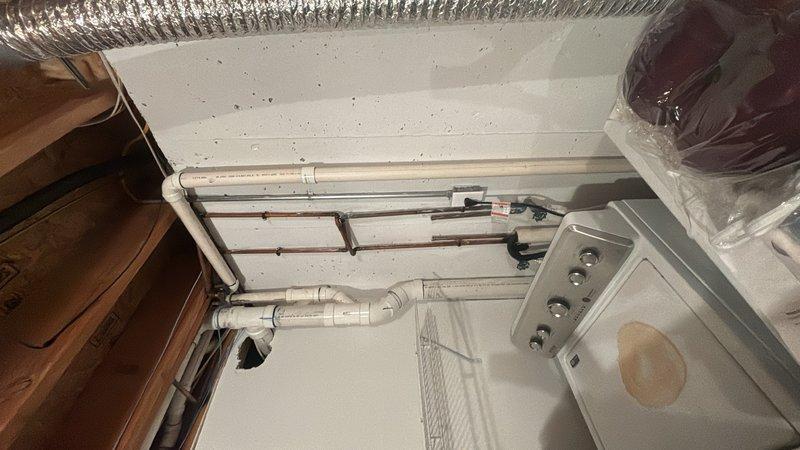 Responded to plumbing maintenance request to inspect wastewater line for possible leak. Conducted thorough visual inspection of accessible plumbing system in utility area, examining overhead PVC drainage lines, copper supply lines, and associated fittings for signs of moisture, corrosion, or active leaks. Performed pressure test on water system using calibrated gauge at wall-mounted connection point to verify system integrity and identify any pressure anomalies that could indicate hidden leaks. All visible plumbing connections, joints, and pipe runs were examined with no evidence of active leakage detected at time of inspection. Documentation photos captured for record.