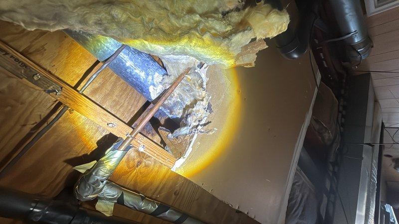Responded to leaking shower faucet in second floor bathroom. Accessed plumbing lines through ceiling cavity to diagnose and repair the water supply issue. Work required opening drywall access panel, exposing PVC supply lines and surrounding insulation to locate source of leak and complete necessary repairs to restore proper faucet operation.