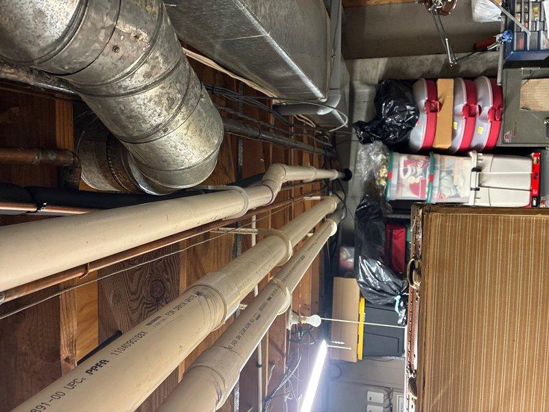 Successfully installed a Rinnai RX199 condensing tankless water heater with 11.0 GPM capacity and 96% efficiency rating in garage location. Removed and properly disposed of existing conventional water heater, capping all abandoned gas lines and venting as required by code.

Installation included running approximately 15 feet of 2-inch PVC piping for both combustion air intake and exhaust venting, terminated with appropriate exterior venting configuration for optimal unit performance. Installed hot and cold water supply lines using Aquapex tubing, ensuring proper connections to existing plumbing system. Gas supply line was extended using black iron pipe with required fittings including tee and elbows, complete with code-compliant dirt leg and emergency shut-off valve for safety.

Routed condensate drainage line to existing floor drain with proper air gap and vent installation below unit to prevent backflow. Verified pre-installation requirement of dedicated 110-volt electrical outlet wa