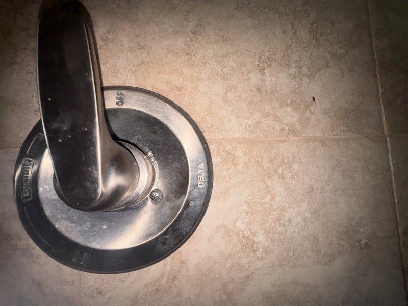 Responded to shower valve malfunction where homeowner had replaced cartridge but experienced severe water spray due to cartridge ejecting from valve body upon water activation. Diagnosed improper cartridge installation and missing or damaged retaining clip that prevented cartridge from seating correctly in valve housing. Removed incorrectly installed cartridge, inspected valve body for damage, and reinstalled cartridge with proper retaining hardware to manufacturer specifications. Tested system operation under full water pressure to verify secure cartridge retention and proper flow control without leaks or spray.