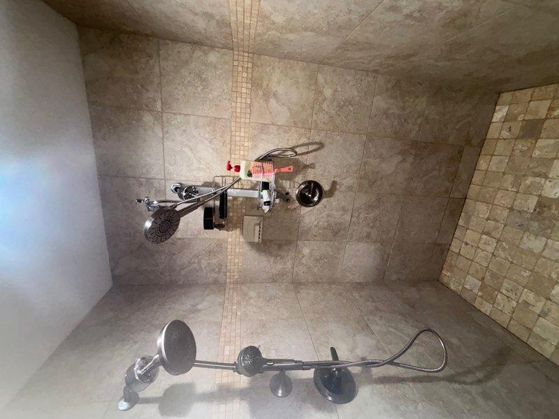 Responded to shower valve malfunction where homeowner had replaced cartridge but experienced severe water spray due to cartridge ejecting from valve body upon water activation. Diagnosed improper cartridge installation and missing or damaged retaining clip that prevented cartridge from seating correctly in valve housing. Removed incorrectly installed cartridge, inspected valve body for damage, and reinstalled cartridge with proper retaining hardware to manufacturer specifications. Tested system operation under full water pressure to verify secure cartridge retention and proper flow control without leaks or spray.