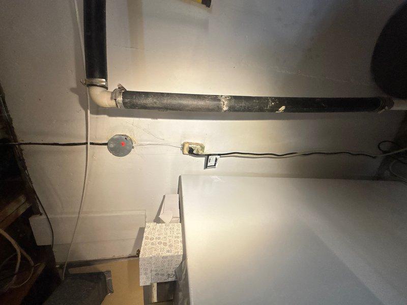 # Sump Pump Installation - Basement Utility Room

Completed sump pump installation in basement utility area per customer request for same-day service. Assessed existing plumbing infrastructure including horizontal drainage pipes, PVC connections, and mechanical equipment layout to determine optimal placement and integration point for new sump pump system. Installed pump unit with proper discharge piping, ensuring adequate connection to existing drainage system and compliance with local plumbing codes. Verified electrical connections and tested pump operation for proper cycling and discharge flow.